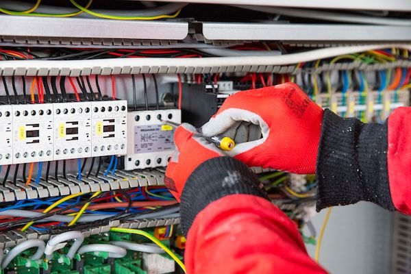 Electrician performing detailed switchboard work, representing high-quality craftsmanship and skil