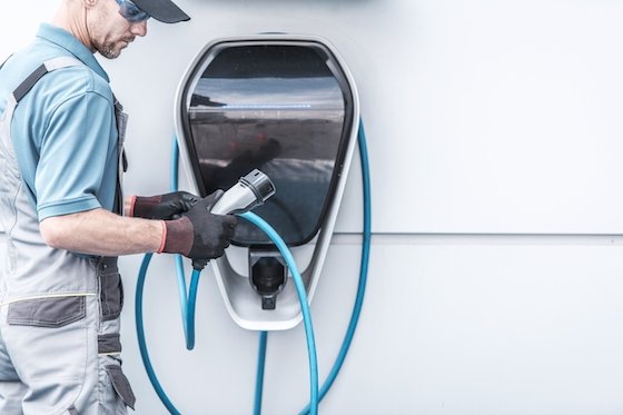 Close-up of a sleek wall-mounted EV charger with a connected charging cable