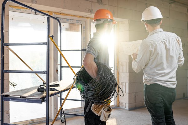 Electricians working on a construction site in Perth, prioritizing safety